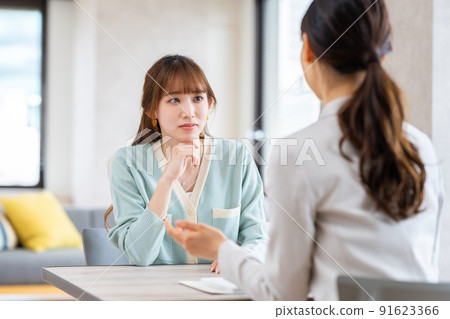 Young woman consulting a planner Young woman consulting a planner 91623366