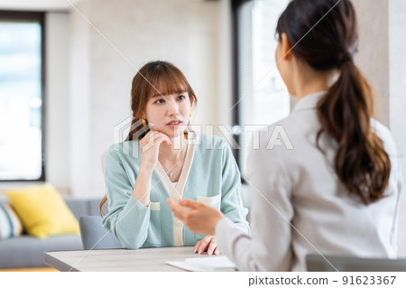 Young woman consulting a planner Young woman consulting a planner 91623367