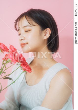 A young woman with flowers A young woman with flowers 91625107