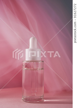 Transparent bottle of cosmetic gel on a pink background. 91627272
