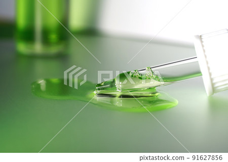 Pipette with fluid serum, oil, face gel cleaner. Cosmetics and healthcare concept closeup. Dose of retinol with air bubbles. Flat lay. Monkeypox, coronavirus research Pipette with fluid serum, oil, face gel cleaner. Cosmetics and healthcare concept closeup. Dose of retinol with air bubbles. Flat lay. Monkeypox, coronavirus research 91627856