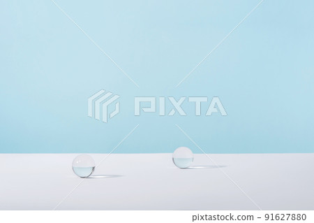 Acrylic glass spheres on blue background for cosmetic or perfume showcase. Creative geometric product stage mock up, cosmetics display wall, product advertising desk, geometric stand 91627880