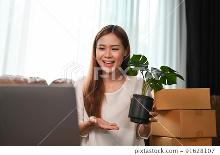 Female online business owner selling her plants on the live streaming on the internet Female online business owner selling her plants on the live streaming on the internet 91628107