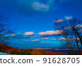 Cityscape and sunset seen from snowy mountains 91628705