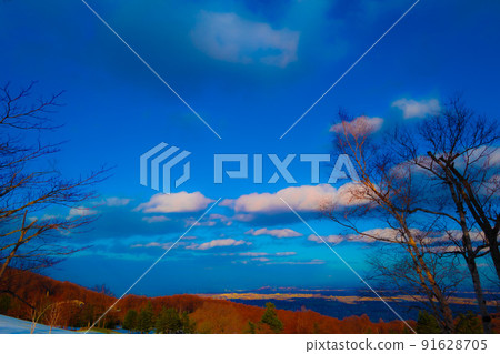 Cityscape and sunset seen from snowy mountains Cityscape and sunset seen from snowy mountains 91628705