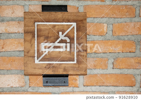 No Smoking Sign on Brick Wall 91628910