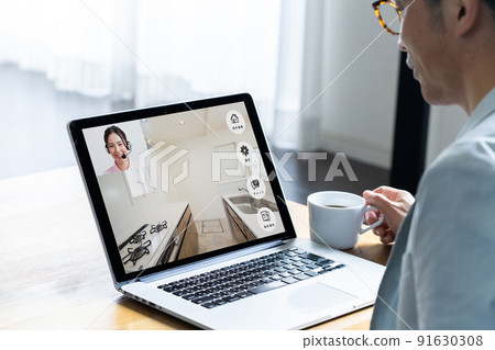 A man viewing a property online 91630308