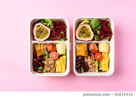 Fresh vegetables salad in biodegradable bowl on pink background, Healthy vegan food Fresh vegetables salad in biodegradable bowl on pink background, Healthy vegan food 91631410
