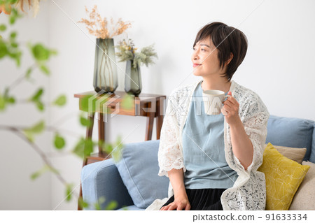 A woman relaxing with coffee etc. A woman relaxing with coffee etc. 91633334