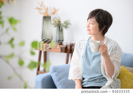 A woman relaxing with coffee etc. A woman relaxing with coffee etc. 91633335