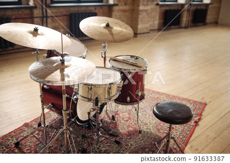Horizontal image of drums set on carpet at empty musical studio 91633387