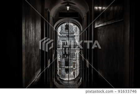 View from Loha Prasat Metal Palace at Ratchanaddaram temple through the gate. Loha Prasat Metal Palace is famous tourist destination in Bangkok, Thailand. 91633746