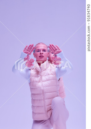 Woman with little girl in futuristic costume wearing smart led glasses of virtual reality while touching air. Augmented reality game, future technology, AI concept. VR. Neon light. Woman with little girl in futuristic costume wearing smart led glasses of virtual reality while touching air. Augmented reality game, future technology, AI concept. VR. Neon light. 91634740