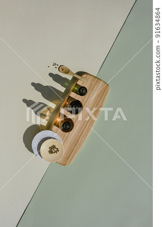 Different bottles with a pipette on a wooden podium with hemp seed 91634864