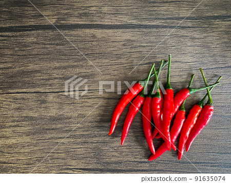 Fresh red chili and space for text on wooden background Fresh red chili and space for text on wooden background 91635074