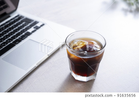 Ice coffee and laptop 91635656