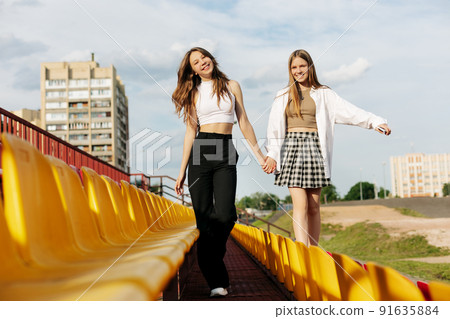 Teenage girls relax together in the school stands. The concept of friendship and relationships 91635884