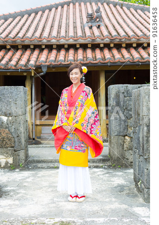 A traveling girl wearing a folk costume in the old Ryukyu Kingdom of Okinawa 91636458