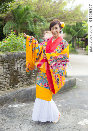 A traveling girl wearing a folk costume in the old Ryukyu Kingdom of Okinawa A traveling girl wearing a folk costume in the old Ryukyu Kingdom of Okinawa 91636507