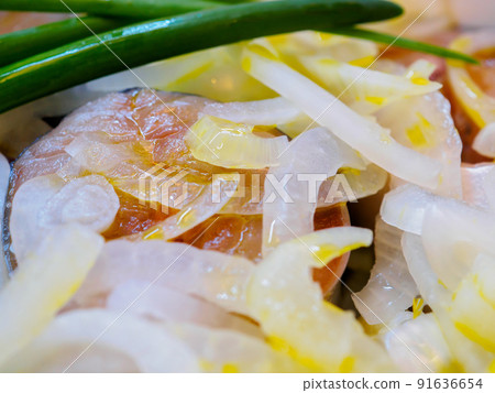 Salted fish sprinkled with chopped onions and sprinkled with vegetable oil. Salted fish sprinkled with chopped onions and sprinkled with vegetable oil. 91636654
