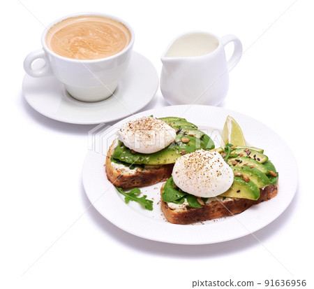 Freshly made poached egg and Avocado toasts isolated on white background 91636956