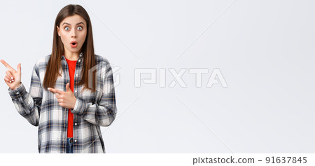 Lifestyle, different emotions, leisure activities concept. Impressed female customer, girl in casual checked shirt, say wow talking about news and pointing fingers left, white background Lifestyle, different emotions, leisure activities concept. Impressed female customer, girl in casual checked shirt, say wow talking about news and pointing fingers left, white background 91637845