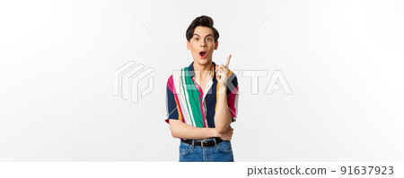 Portrait of young handsome guy having an idea, raising finger and saying suggestion, standing over white background Portrait of young handsome guy having an idea, raising finger and saying suggestion, standing over white background 91637923