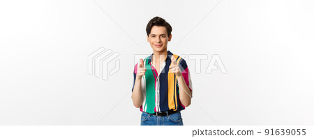 Confident handsome man encourage you, pointing fingers at camera and smiling, being supportive, standing over white background Confident handsome man encourage you, pointing fingers at camera and smiling, being supportive, standing over white background 91639055