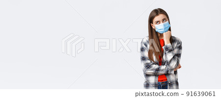 Coronavirus outbreak, leisure on quarantine, social distancing and emotions concept. Thoughtful and gloomy young woman hate staying home self-isolation, dreaming go vacation, wear medical mask Coronavirus outbreak, leisure on quarantine, social distancing and emotions concept. Thoughtful and gloomy young woman hate staying home self-isolation, dreaming go vacation, wear medical mask 91639061