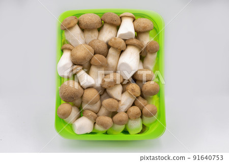 Pleurotus eryngii mushrooms closeup in plastic box. 91640753