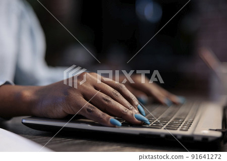 Close up shot of brokerage company professional agent sitting at desk in office while using laptop to analyze real time financial data. Hedge fund trader in workspace working on computer. Close up shot of brokerage company professional agent sitting at desk in office while using laptop to analyze real time financial data. Hedge fund trader in workspace working on computer. 91641272