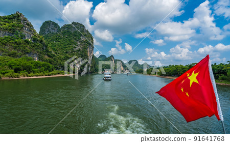 Red Chinese national flag on a boat sailing on Li River 91641768