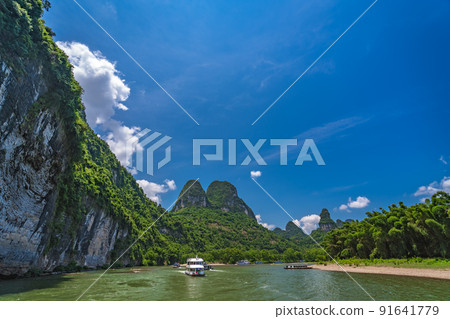 Tourist boat sailing on a Li River in China Tourist boat sailing on a Li River in China 91641779