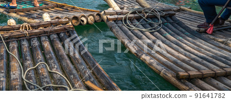 Close up of bamboo rafts on a tropical river Close up of bamboo rafts on a tropical river 91641782