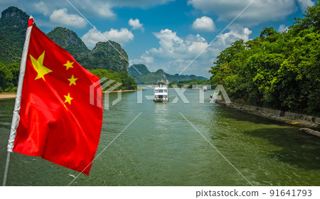Red Chinese national flag on a boat sailing on Li River 91641793