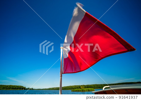 Polish flag on a boat on Jezioro Ostrowieckie in Poland Polish flag on a boat on Jezioro Ostrowieckie in Poland 91641937