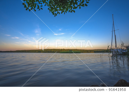 Amazing shot of a reflective lake on a beautiful sunset background 91641958