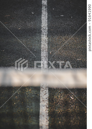 Selective focus shot of a tennis court under the sunlight 91641990