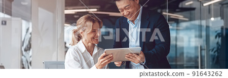 Business people in office meeting for project and discuss it using laptop and tablet Business people in office meeting for project and discuss it using laptop and tablet 91643262