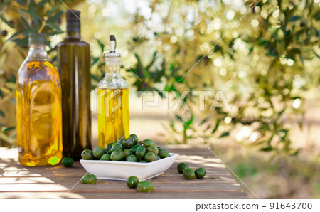 green olives and oil on table in olive grove green olives and oil on table in olive grove 91643700