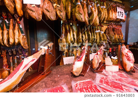 Legs of traditional Spanish jamon fixed on wooden jamoneras ready for sale Legs of traditional Spanish jamon fixed on wooden jamoneras ready for sale 91643803