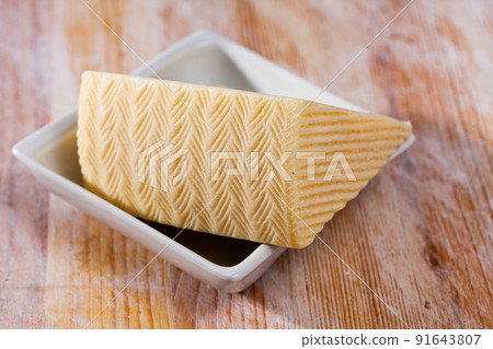 Piece of fresh semi-soft cheese Piece of fresh semi-soft cheese 91643807