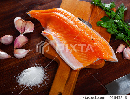 Raw trout fillet on wooden table Raw trout fillet on wooden table 91643848
