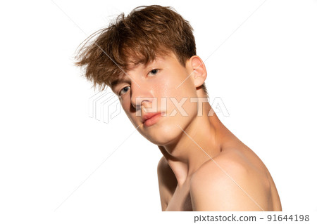 Beauty portrait of young man, teen isolated on grey studio background. Concept of teenage skin care, health, cosmetics for problem skin, youth Beauty portrait of young man, teen isolated on grey studio background. Concept of teenage skin care, health, cosmetics for problem skin, youth 91644198
