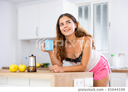 Portrait of girl having breakfast in the kitchen. Morning coffee Portrait of girl having breakfast in the kitchen. Morning coffee 91644199