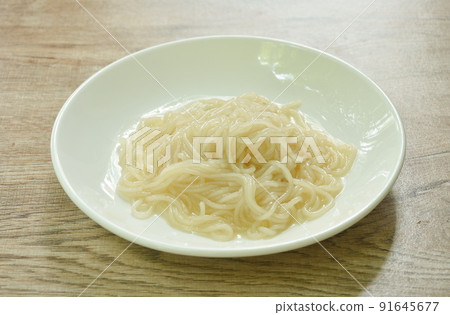 dry Vietnamese rice noodles or Pho with soup on plate 91645677