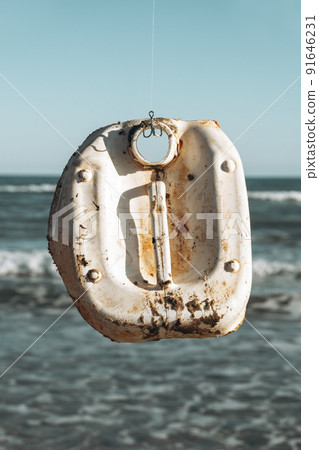 used white plastic bottle hanging from a fish hook used white plastic bottle hanging from a fish hook 91646231