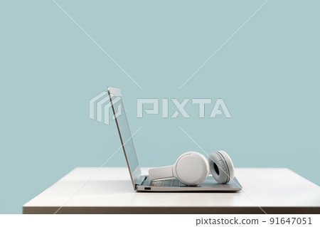 Laptop with wireless headphones on white desk Laptop with wireless headphones on white desk 91647051