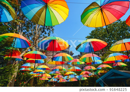 Background of colorful rainbow umbrella street decoration 91648225