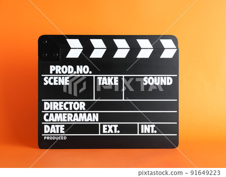 Clapper board on orange background. Cinema production 91649223